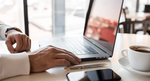man-working-from-home-kitchen-with-laptop-2.webp